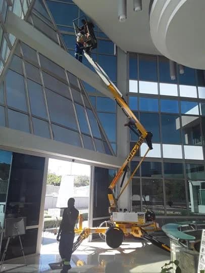 High Rise Cleaners at boom lift glass building